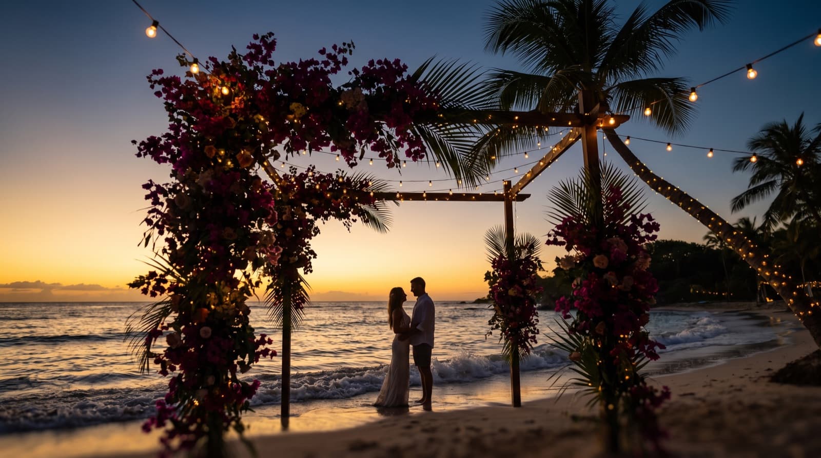 A couple beneath a floral arch at golden hour on a Guam beach